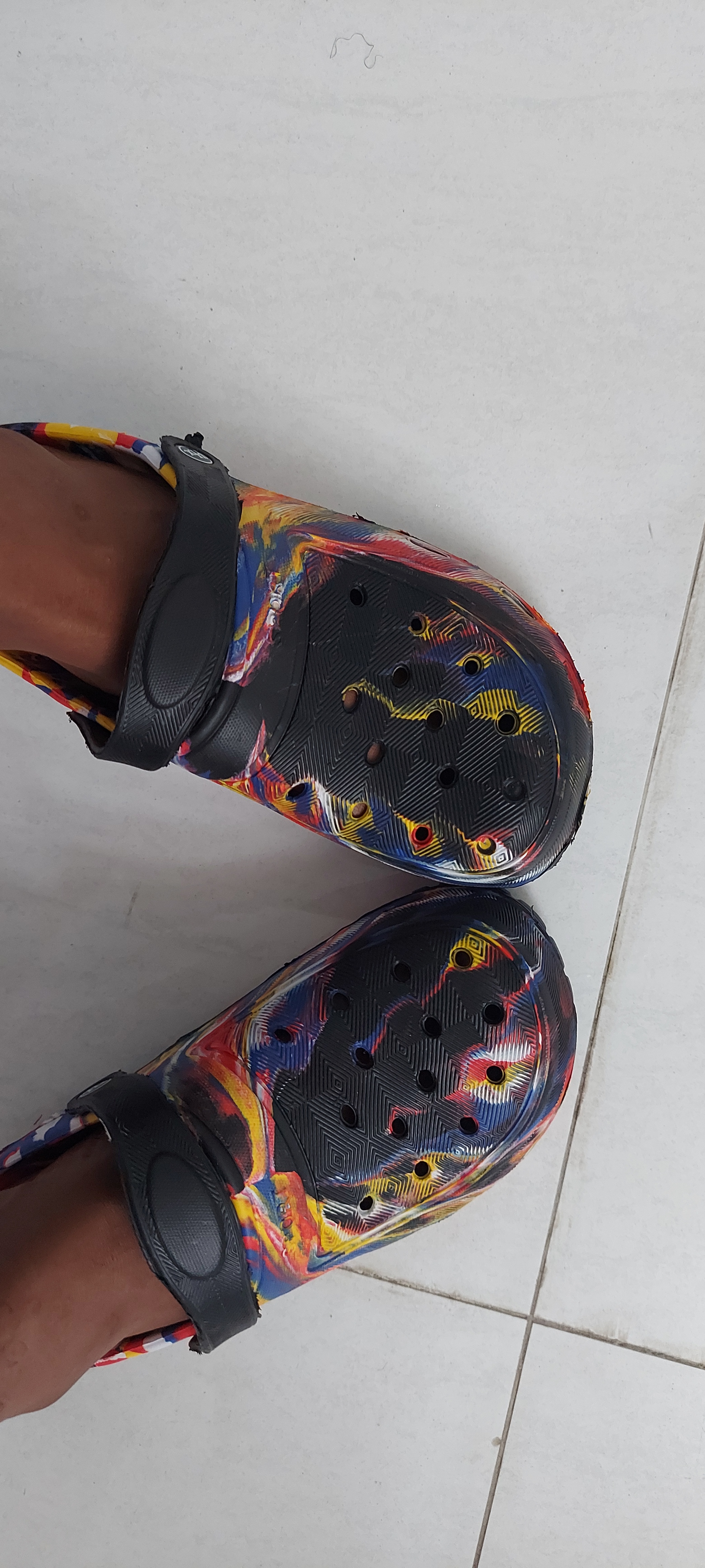 A feet in multi coloured crocs